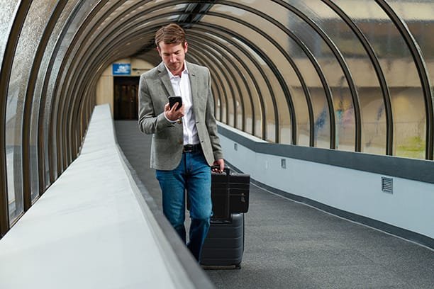man walking through walkway tunnel