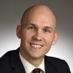 Ryan Allen smiling in a black suit
