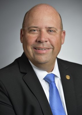 Kerry Bickett smiling in a suit