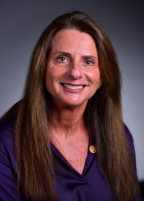 Tammy Carroll smiling wearing a purple blouse
