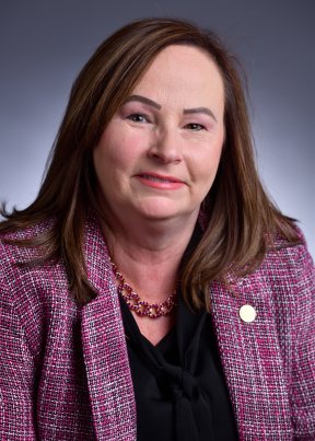 Patricia Chamness wearing a pink and black suit
