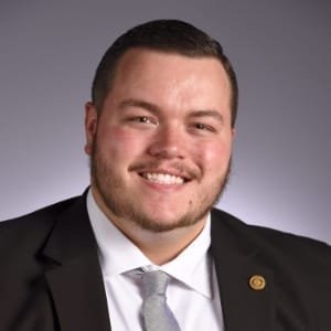 Trevor Humphrey smiling in a dark suit