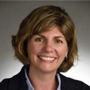 Andrea Smith smiling in a dark suit