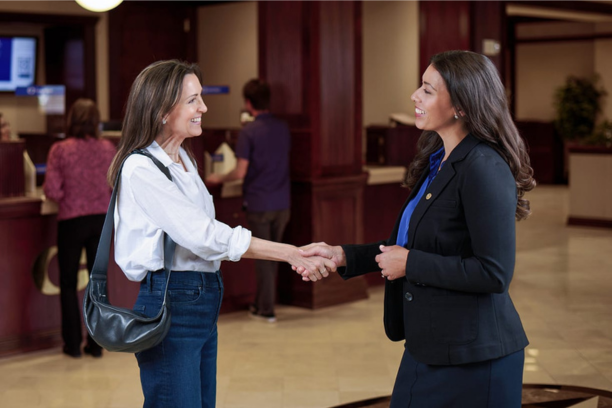 two women sharing a handshake